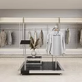 Modern Clothing Store Interior With Hanging Clothes Racks Display Stand And Potted Plants