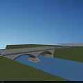 Arch Bridge With White Railings Surrounded By Green Grass And Blue Water Surface