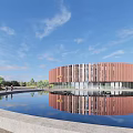 Modern Round Museum Building With Red Facade Waterfront Path And Cyclist