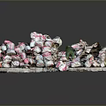 Pile Of Broken Ceramic Fragments With Pink And White Patterns And Small Green Object