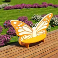 Butterfly Shaped Landscape Bench In Garden With Flowers And Blue Sky