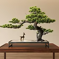 Decorative Ornament Set With Bonsai Pine Tree And Deer Figurine On Wooden Table