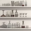 Glass Kitchenware On White Shelves With Wine Glasses Decanters And Bottles
