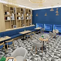 Modern Restaurant Interior With Blue Walls Bookshelves Chandeliers And Geometric Floor