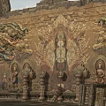 Traditional Scenic Wall With Intricate Dragon Carvings And Central Buddha Statue