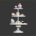 Three Tiered White Display Shelf with Assorted Desserts Including Cupcakes Ice Cream Cones and Macarons