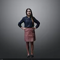 Woman In Blue Shirt And Pink Skirt Standing With Hands On Hips Against Gray Background