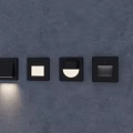 Black Square Wall Lighting Fixtures With Various Designs And Illuminated Unit On Dark Wall