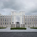 Modern Office Building Exterior With Symmetrical Design Large Windows And Landscaped Plaza
