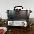 Modern Electric Kitchen Cooker With Olive Oil Bottle Fresh Tomato And Asparagus On Wooden Table