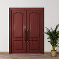 Dark Red Wooden Double Door With Decorative Panels And Golden Handles Beside Green Potted Plant