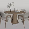 Minimalist Light Wood Round Dining Table Set with Four Upholstered Chairs and Green Plant Vase
