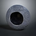 Grey Round Sculpture Carving With Intricate Spiral Patterns And Hollow Center