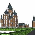 Castle Style Building With Red Brick Structure And Tall Spires Near Green Hedges