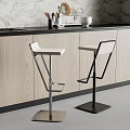Modern Bar Stools With White Seats And Metal Frames At Kitchen Counter With Wooden Cabinets
