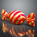 Red and White Striped Candy Wrapped in Gold Foil with Shiny Reflection on Black Surface