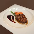 Grilled Steak Plated with Green Vegetables Carrots and Red Sauce on White Square Plate