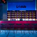 L'1 Club Bar Interior With Blue Neon Background And Bottle Shelves Bar Counter Black Stools