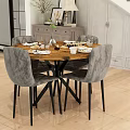 Modern Dining Room Featuring Round Wooden Table Gray Upholstered Chairs And Arranged Tableware