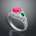 Silver Ring Featuring Red Central Gemstone Green Accent Stones And Intricate Carvings