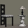 Modern Black Frame Chair With Circular Cutouts And White Marble Table Lamp