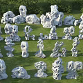Natural Taihu Stones and Wooden Accents Arranged on Green Lawn Area