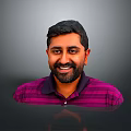 Man with short black hair and beard wearing purple striped polo shirt against gray background
