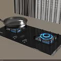 Modern Black Glass Gas Cooktop With Silver Frying Pan On Kitchen Countertop
