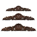 Artistic Dark Wood Carvings Showcasing Intricate Shell Shapes And Scrollwork Patterns