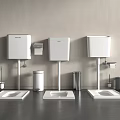 Three White Toilet Tanks Side By Side With Squat Pans Accessories Dark Floor Light Wall