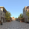 Traditional Commercial Street With Cobblestone Pavement Arched Window Buildings Trees Benches And Tower Structures