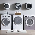 Three Modern Washing Machines White And Purple With Wall Mounted Dryers Towels And Laundry Balls