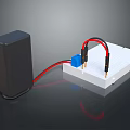 Black Power Supply Connected To White Circuit Board With Blue Component And Red Black Wires
