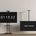 Two Black TVs on Stands Showing Digital Numbers and Paint It Black Text Against White Wall