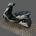 White And Black Electric Scooter With Black Seat Parked On Brick Pavement