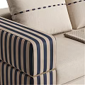 Stylish Beige Sectional Sofa With Striped Armrests Decorative Pillows And Throw Blanket