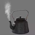 Black Electric Kettle With Metal Handle And Steam Rising From Spout