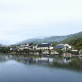Modern Commercial Complex with Mountain View and Lake Reflection in Natural Landscape