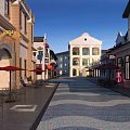 Commercial Street Featuring European Style Buildings Outdoor Dining Areas And Cobblestone Pavement