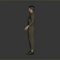 Man in Green Overalls Standing with Hands Naturally Hanging Down on Gray Background
