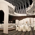 Elegant Banquet Hall Interior With White Arches Crystal Chandeliers And White Tables