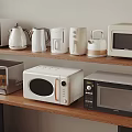 Various Kitchen Appliances Including Toaster Kettle Coffee Maker And Microwaves On Wooden Shelf