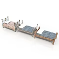Vintage Style Beds With Ornate Metal And Wooden Frames And Patterned Blue Mattresses