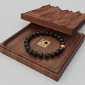 Wooden Box With Open Lid Holding Black Beaded Bracelet Featuring Gold Square Charm