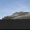 Modern Office Building With Unique Curved Design Glass Curtain Walls Surrounding Trees And Illuminated Exterior