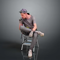 Man sitting on ladder wearing gray t-shirt pants hat and gloves holding tools