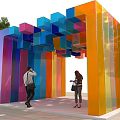 Colorful Geometric Outdoor Structure With Vibrant Hanging Cubes Stripes And Visitors