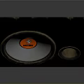 Black Audio Speaker With Orange JBL Logo And Worn Exterior Design