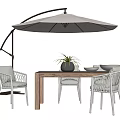 Outdoor Table and Chairs Set Wooden Top White Woven Chairs Umbrella Plant and Bowls