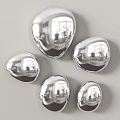 Shiny Silver Teardrop Shaped Wall Decor Arranged on Grey Wall 3d model